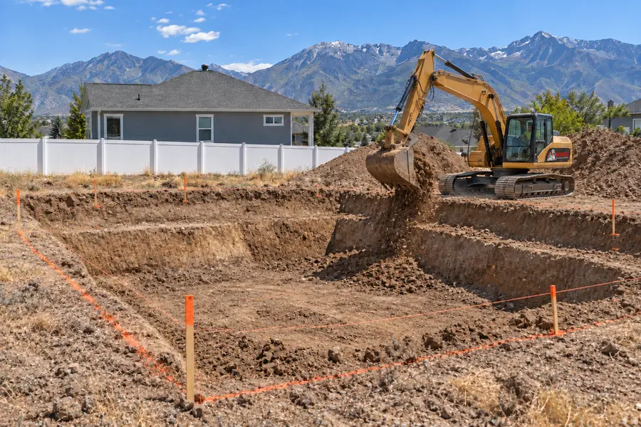 Wolves excavator digging a basement foundation on a Utah building site